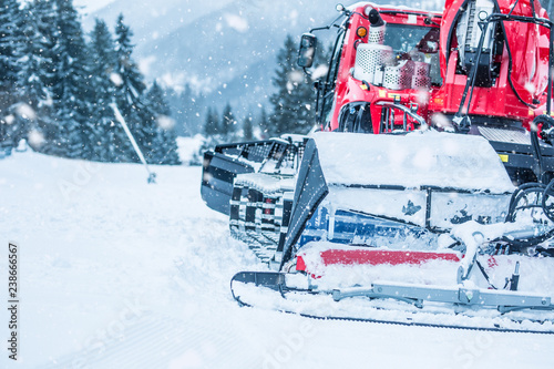 Tableau sur toile Red ratrac snowcat at work on on the ski slope