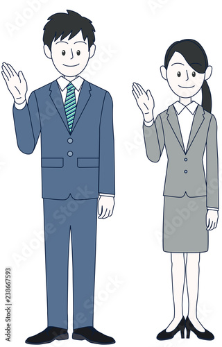 手で案内をする若い男性と女性ビジネスマン