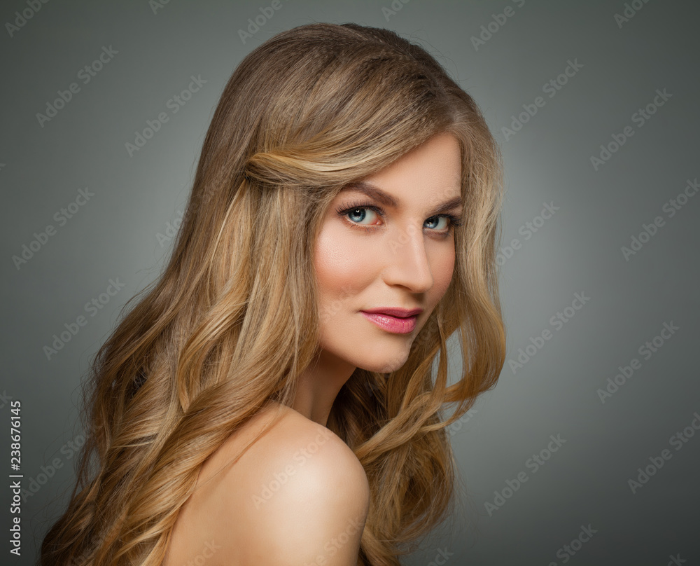 Naklejka premium Cute blonde woman with long healthy hair and clear skin portrait