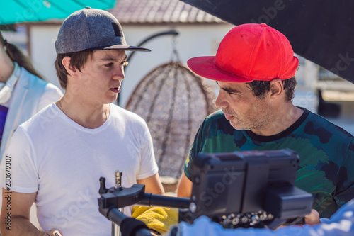 camera operator, director of photography and director discuss the process of a commercial video shoot