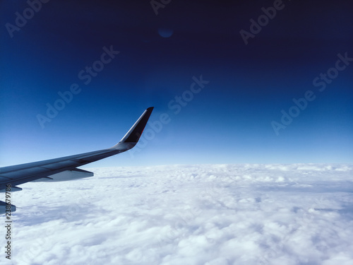 Aerial View from the Airplane Window Airplane Wing and Clouds blue sky freedom travel