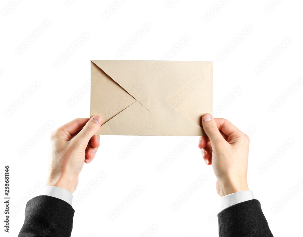 The hands in white shirt and black jacket holding the envelope. Close up. Isolated on white background The hands in white shirt and black jacket holding the envelope. Close up. Isolated on white background