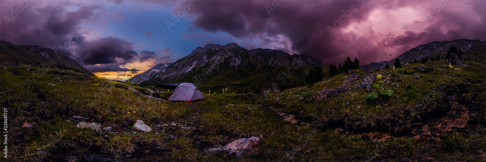 tent in the mountains against the backdrop of purple clouds at sunset. Cylindrical 360 panorama