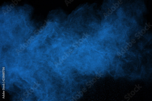 abstract blue powder splatted background. Colorful powder explosion on black background. Colored cloud. Colorful dust explode. Paint Holi.