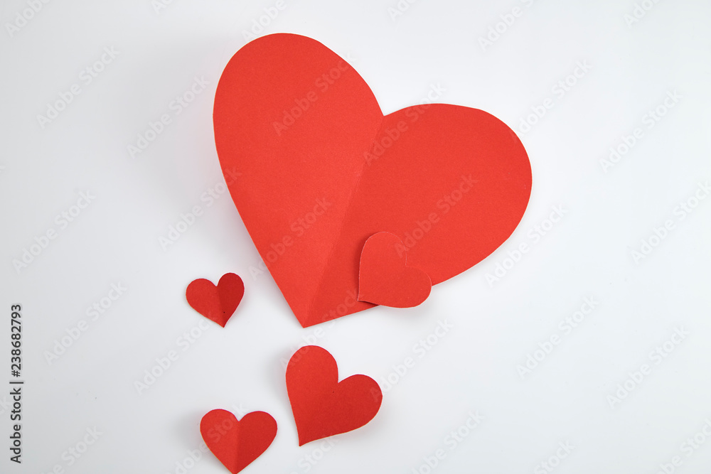 Paper red hearts on white background