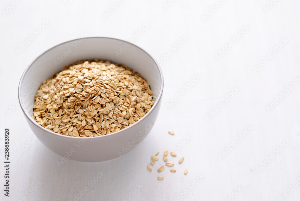 White bowl of dry oatmeal