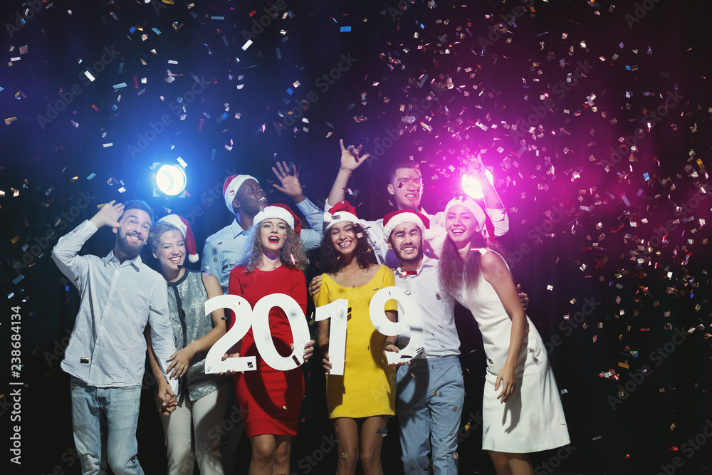 Fototapeta Multiracial friends celebrating New Year at party