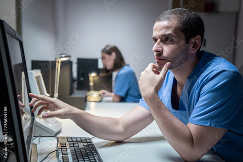 Health Care Workers In Hospital With Computer And Equipment