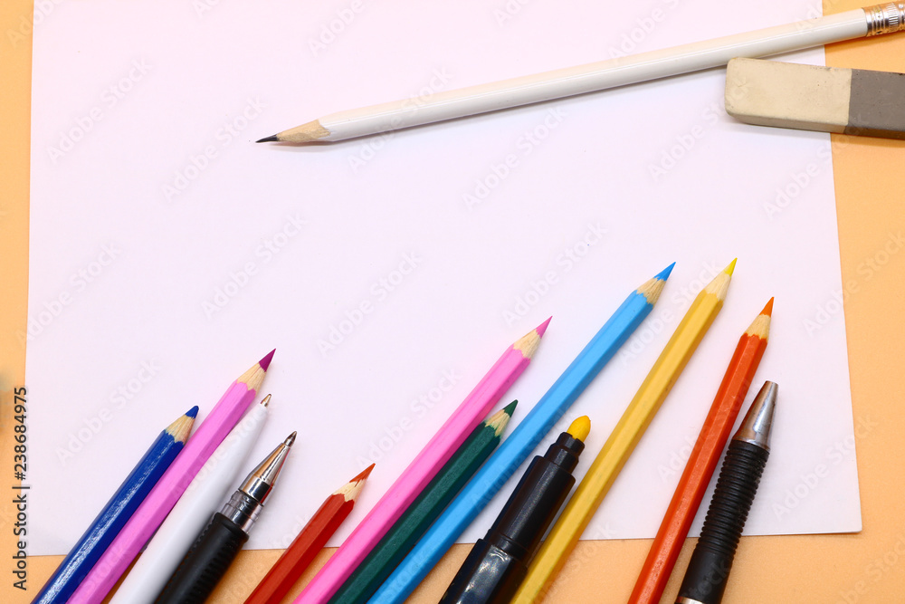 colored pencils and a clean sheet of paper colored pencils and a clean sheet of paper