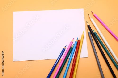 colored pencils and a clean sheet of paper