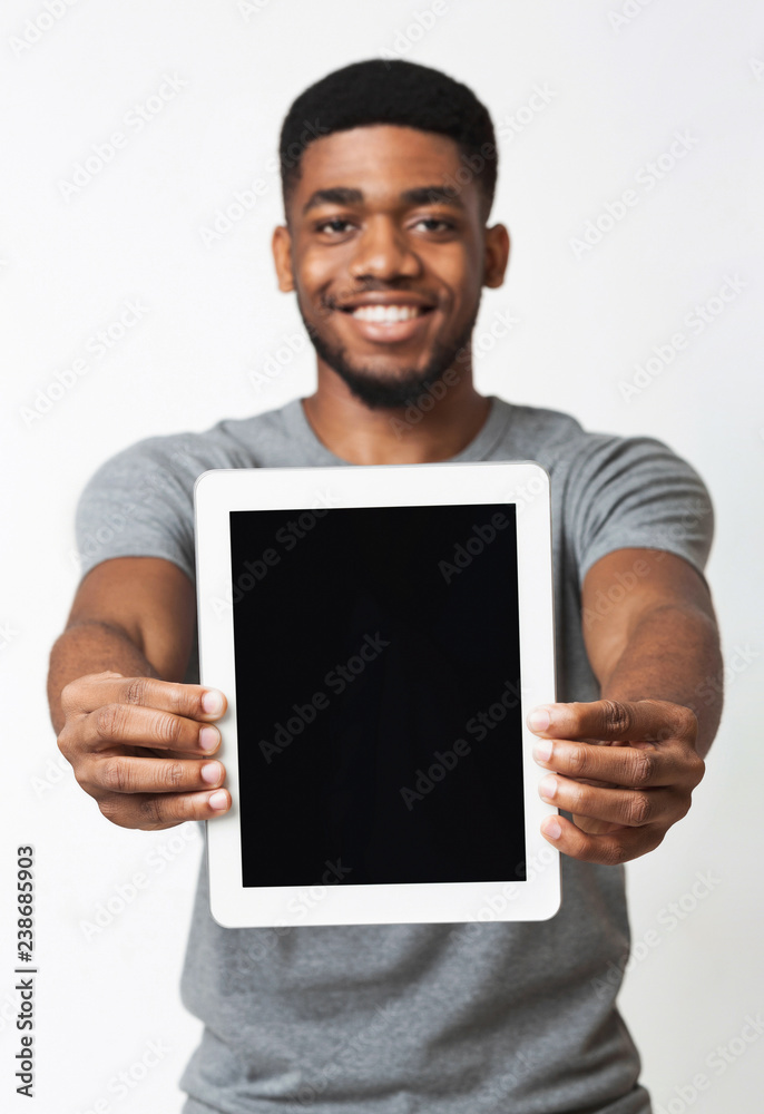 African-american man showing blank digital tablet screen African-american man showing blank digital tablet screen