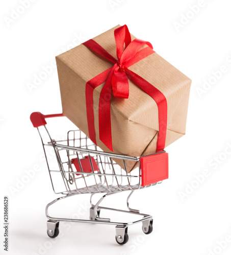 Cardboard gift box in shopping cart on white background