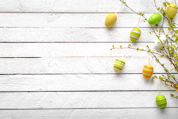 Happy easter egg with pattern. Colored eggs on white wooden background.