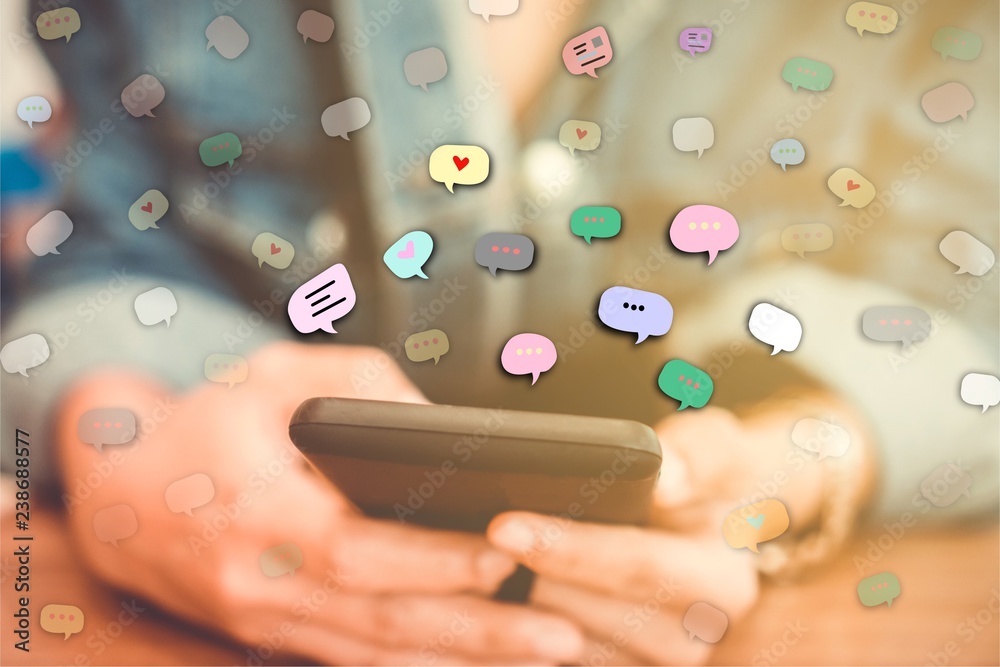 Woman hand using smartphone with chat icon in cafe shop background. Woman hand using smartphone with chat icon in cafe shop background.