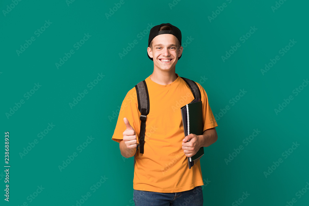 Recommend. Teenager showing thumb up and holding books Recommend. Teenager showing thumb up and holding books