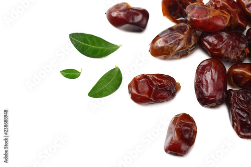 date fruits with green leaves isolated on white background. top view