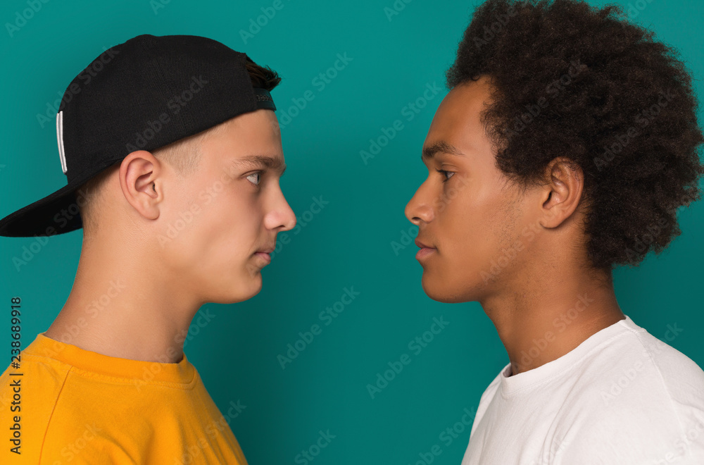Two teens looking at each other after conflict Two teens looking at each other after conflict