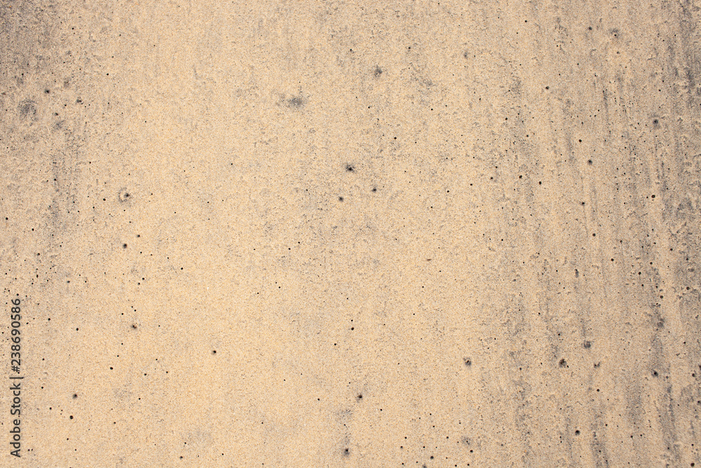 Texture of wet yellow and black sand Texture of wet yellow and black sand