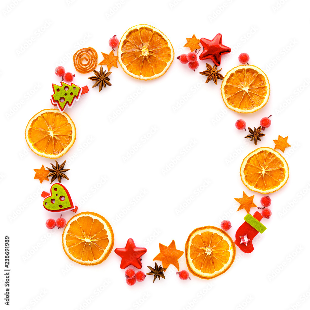 Naklejka Round frame with dried orange, christmas decorations, anise stars on white background. Flat lay, top view