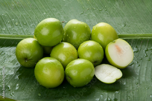 Fruit : Close up of Indian Jujube Apple Isolated on Green Banana Leaf Background Shot   in Studio