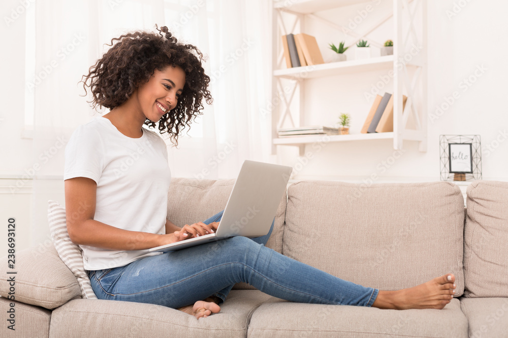African-american woman working on laptop computer at home African-american woman working on laptop computer at home