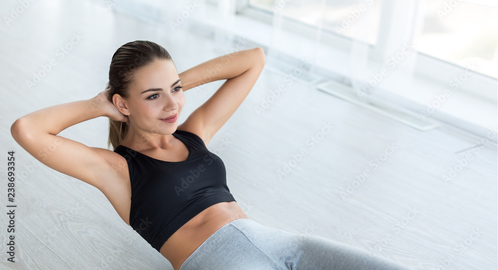 Woman doing abs situps on floor at home