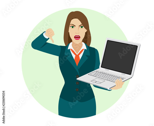 Businesswoman holding a laptop notebook and showing thumb down gesture as rejection symbol
