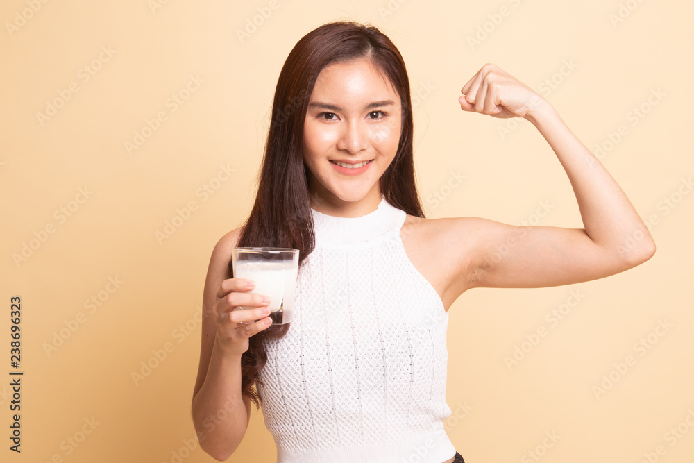 Healthy Asian woman drinking a glass of milk. Healthy Asian woman drinking a glass of milk.