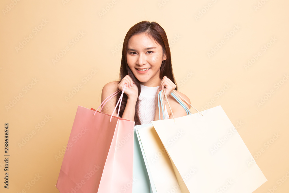 Beautiful young Asian woman with shopping bags.