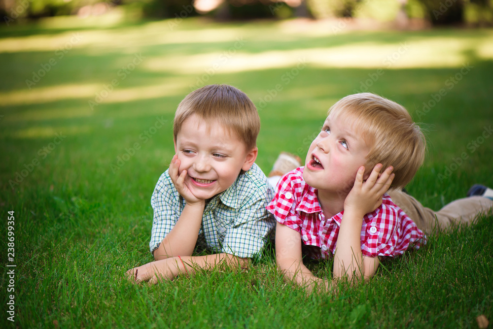 Two young boys walk and relax in the park. Two young boys walk and relax in the park.