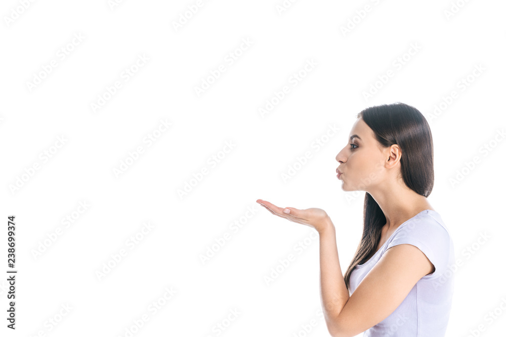 side view of young beautiful woman blowing kiss isolated on white side view of young beautiful woman blowing kiss isolated on white