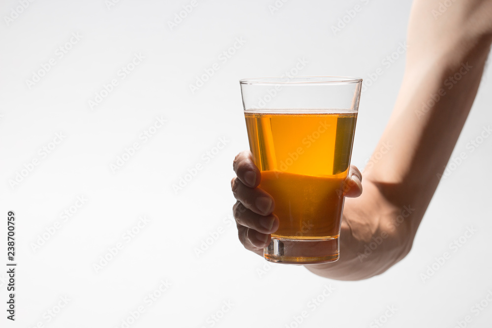 Hand holding glass of craft beer on white background Hand holding glass of craft beer on white background