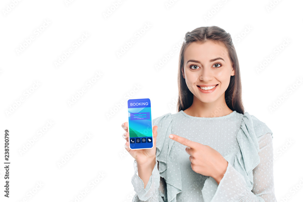 smiling woman showing smartphone with booking lettering isolated on white smiling woman showing smartphone with booking lettering isolated on white