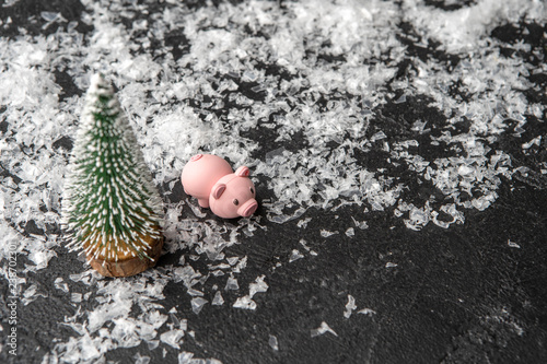 Image of piggy, artificial Christmas tree, snow
