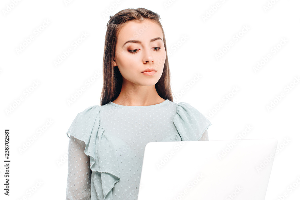 portrait of young focused woman with laptop isolated on white
