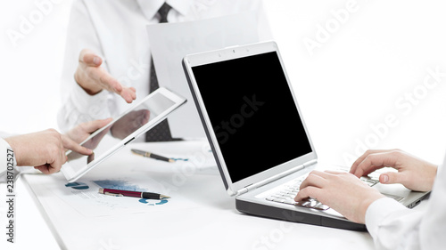 close up.the businessman uses a digital tablet to find partners.business concept