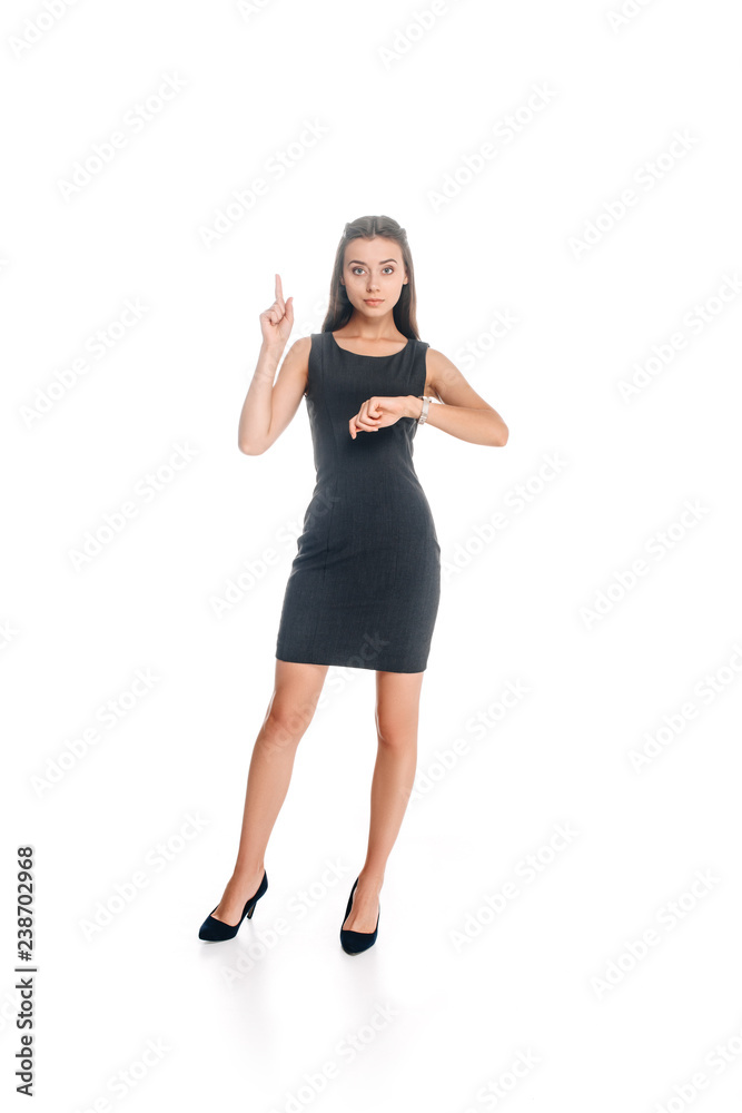 Fototapeta premium woman in stylish black dress checking time isolated on white
