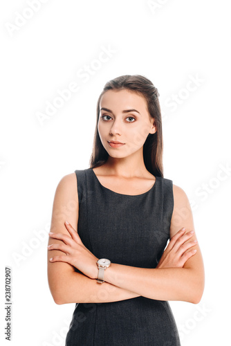 portrait of young woman in black dress with arms crossed isolated on white © LIGHTFIELD STUDIOS