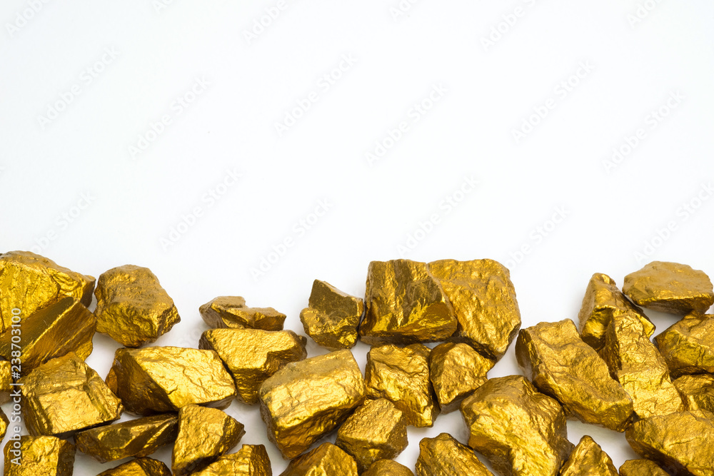 A pile of gold nuggets or gold ore on white background, precious stone or lump of golden stone, financial and business concept. A pile of gold nuggets or gold ore on white background, precious stone or lump of golden stone, financial and business concept.