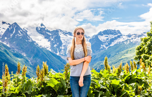 Beautiful blonde on the background of mountain landscape