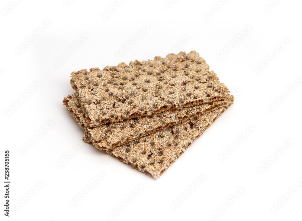 A pile of three crunchy wheat rye brown crackers, isolated on white background. Healthy food concept. A pile of three crunchy wheat rye brown crackers, isolated on white background. Healthy food concept.