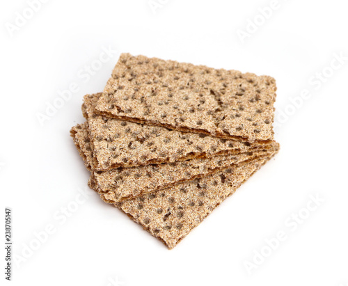 A pile of four crunchy wheat rye brown crackers, isolated on white background. Healthy food concept. photo