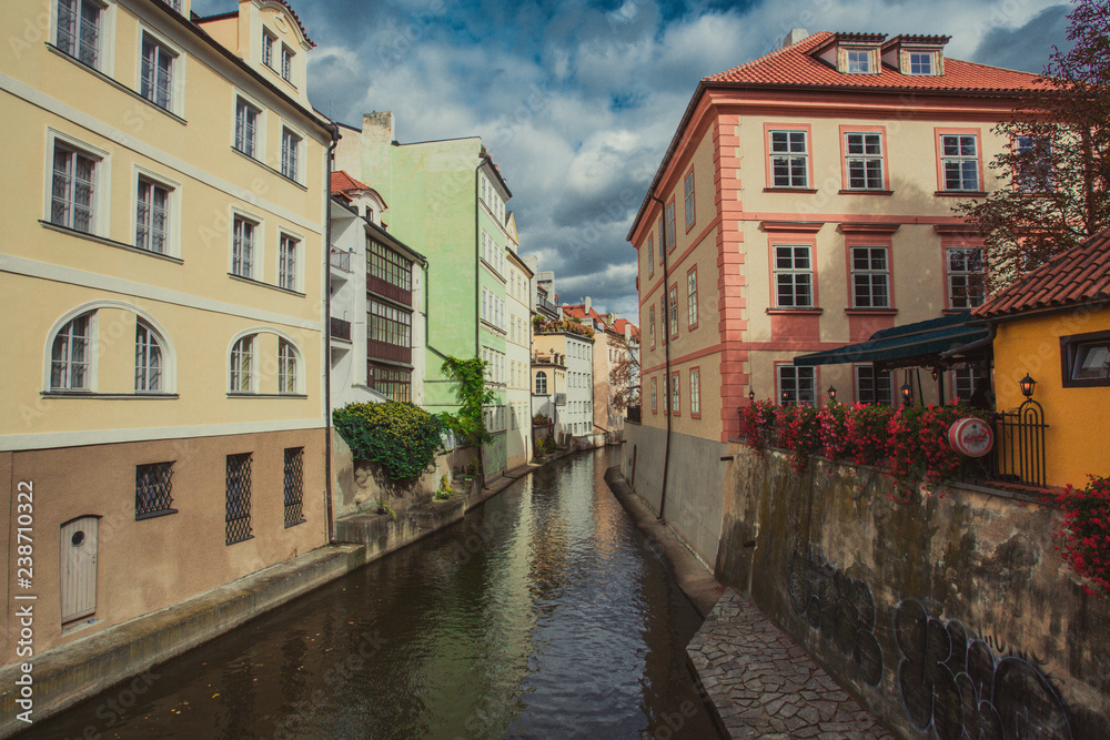 Czech Republic, Prague, Certovka river, Devil's Channel, also called Little Prague Venice between Kampa island and Mala strana in Czech Republic with Historic Mill Wheel and boat