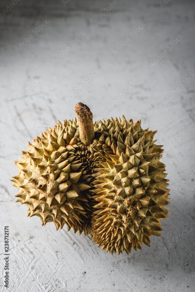 Durian exotic fruit from Asia on concrete table Durian exotic fruit from Asia on concrete table