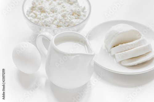 monochrome concept with dairy products on white table