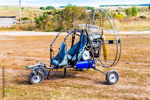 Closeup of moto paraglider on the field.