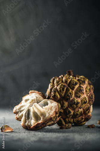 Sugar apple  Annona fruit  Cherimoya or Custard apple. Exotic fruit from tropical countries on table. Sweet flesh. Healthy food with vitamin