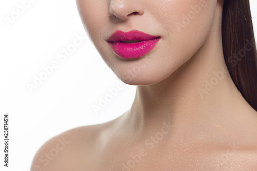 Closeup of beautiful female mouth with pink lip makeup.