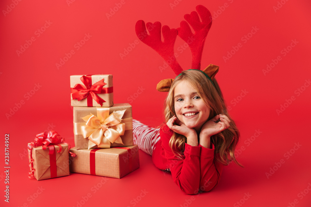 Cheerful little girl wearing Christmas raindeer costume Cheerful little girl wearing Christmas raindeer costume