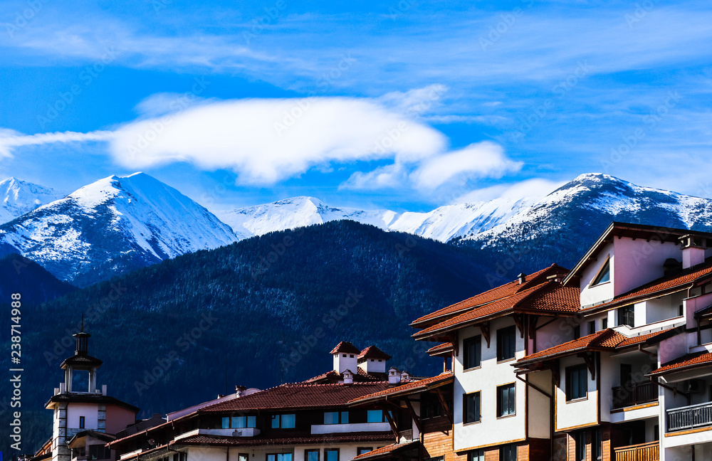 Mountain snow peak, Alpine village houses. Europe, old town winter ice hill top panoramic view.